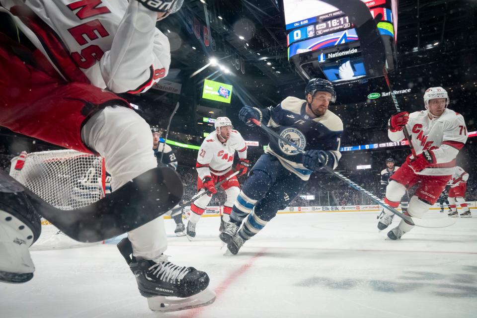 Feb 29, 2024; Columbus, Ohio, USA; Columbus Blue Jackets center Sean Kuraly (7) chases down a puck in the corner with Carolina Hurricanes right wing Jesper Fast (71) during the second period of the NHL hockey game at Nationwide Arena.