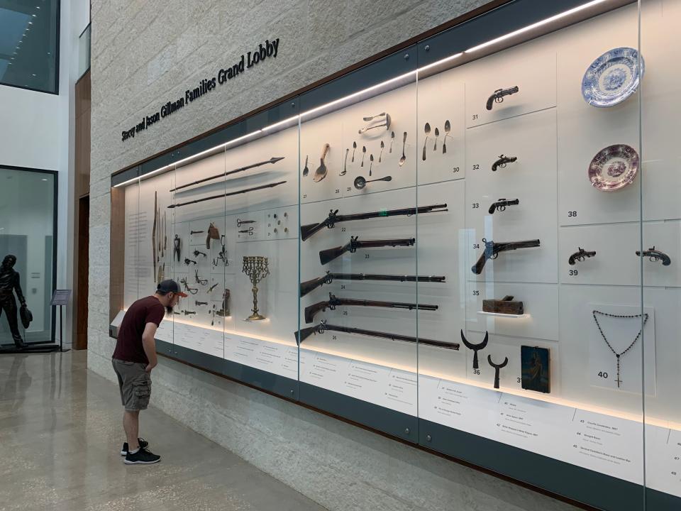 The tricentennial of the Alamo's move to its current site will be celebrated in 2024. Here a visitor examines artifacts at the new Ralston Family Collections Center in the Alamo complex.