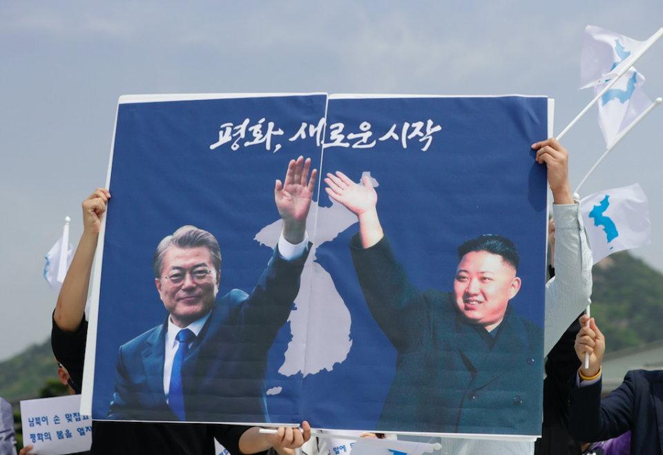 <em>South Koreans hold a banner to welcome the planned summit (PA)</em>