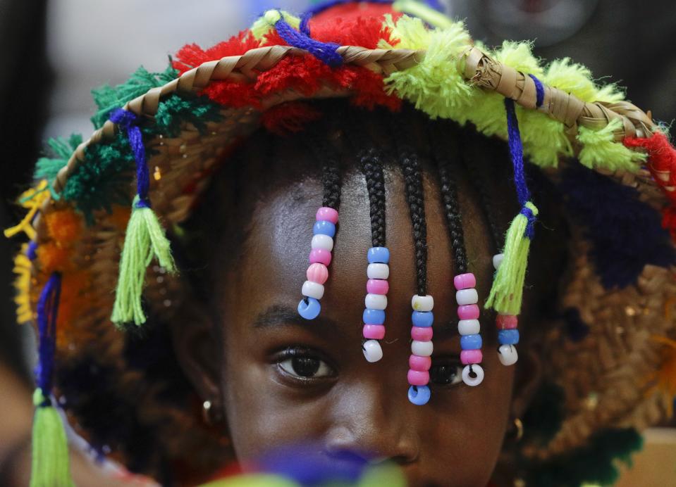 A girl waits for Pope Francis at the diocesan Caritas center in Rabat, Morocco, Saturday, March 30, 2019. Francis's weekend trip to Morocco aims to highlight the North African nation's tradition of Christian-Muslim ties while also letting him show solidarity with migrants at Europe's door and tend to a tiny Catholic flock on the peripheries. (AP Photo/Gregorio Borgia)