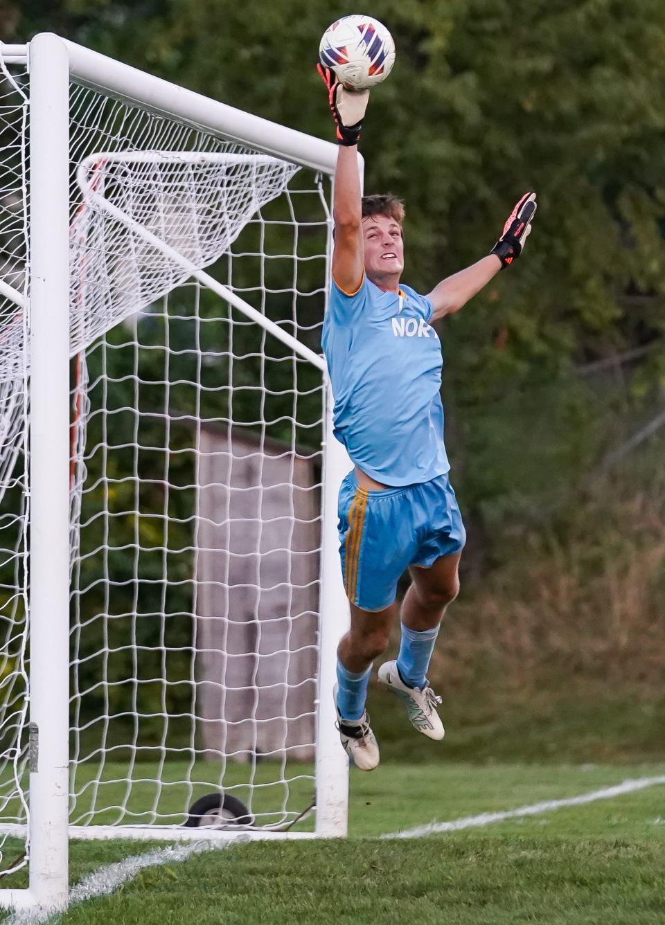 Bloomington North goalkeeper Dylan Stegemoller makes the leaping save on a free kick during the North-South boys’ soccer match at South on Thursday, September 14, 2023.