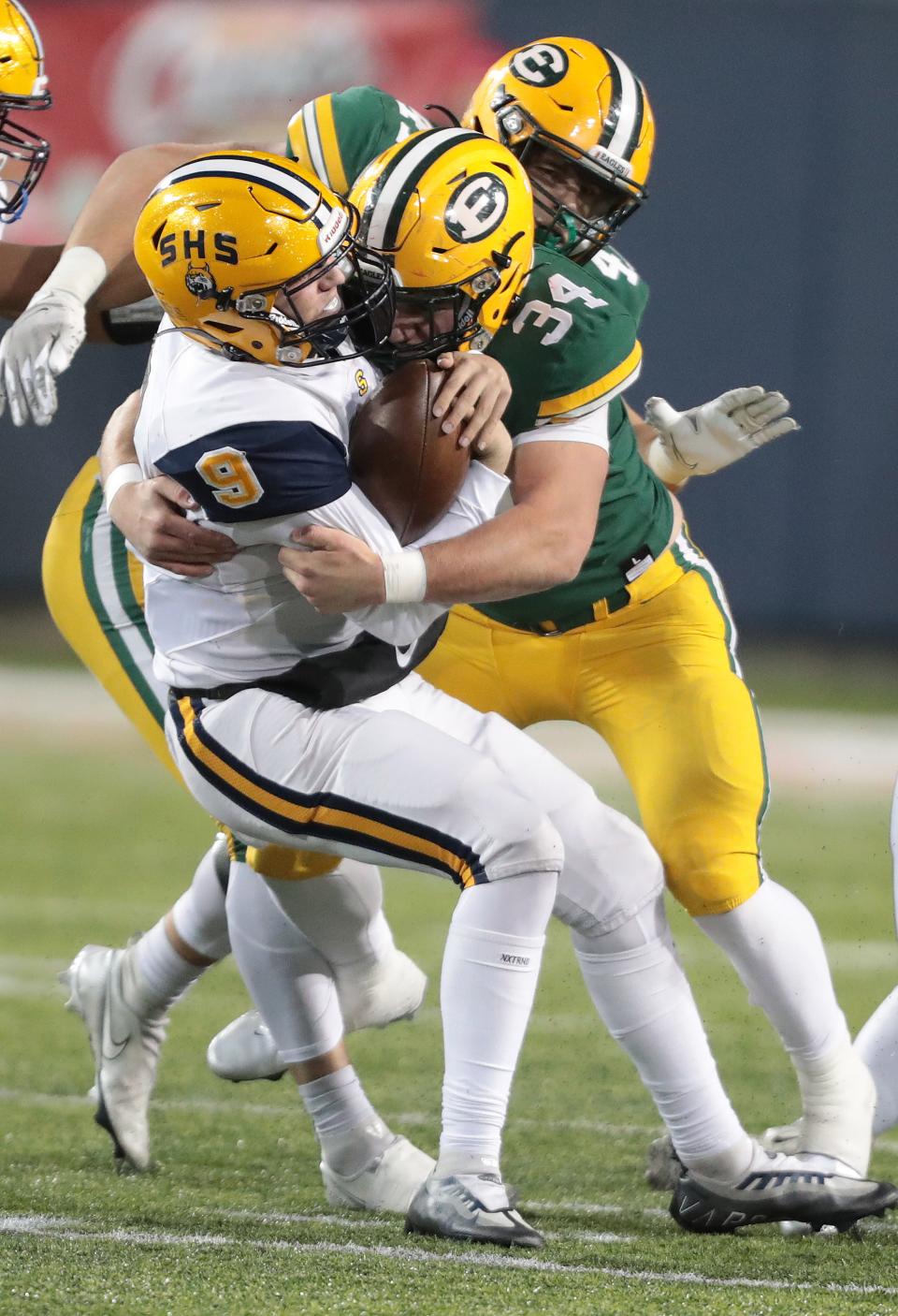 Springfield quarterback Bryce Schondelmyer is sacked by St. Edward's Wyatt Gedeon in the second half during the Division I state championship game at Tom Benson Hall of Fame Stadium in Canton, Friday, Dec. 2, 2022.