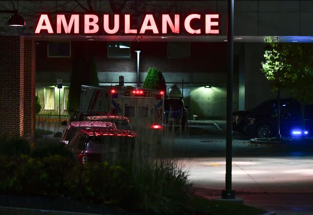 <p>JOSEPH PREZIOSO/AFP via Getty</p> Law enforcement officials (R) guard the ambulance entrance to Central Maine Medical Center