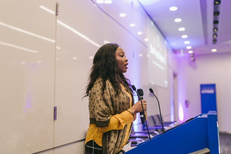 Mary Agbesanwa speaking at an event.