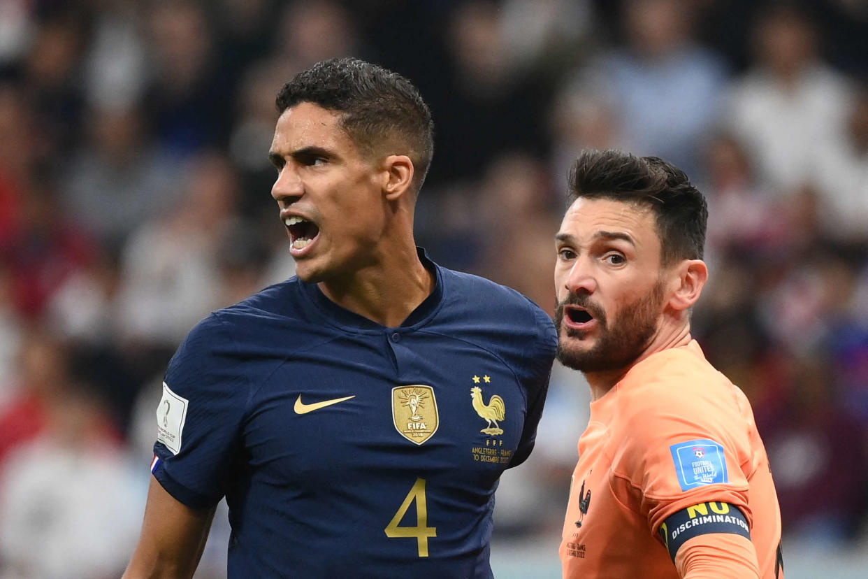 France's defender #04 Raphael Varane (L) reacts next to France's goalkeeper #01 Hugo Lloris during the Qatar 2022 World Cup quarter-final football match between England and France at the Al-Bayt Stadium in Al Khor, north of Doha, on December 10, 2022. (Photo by FRANCK FIFE / AFP)