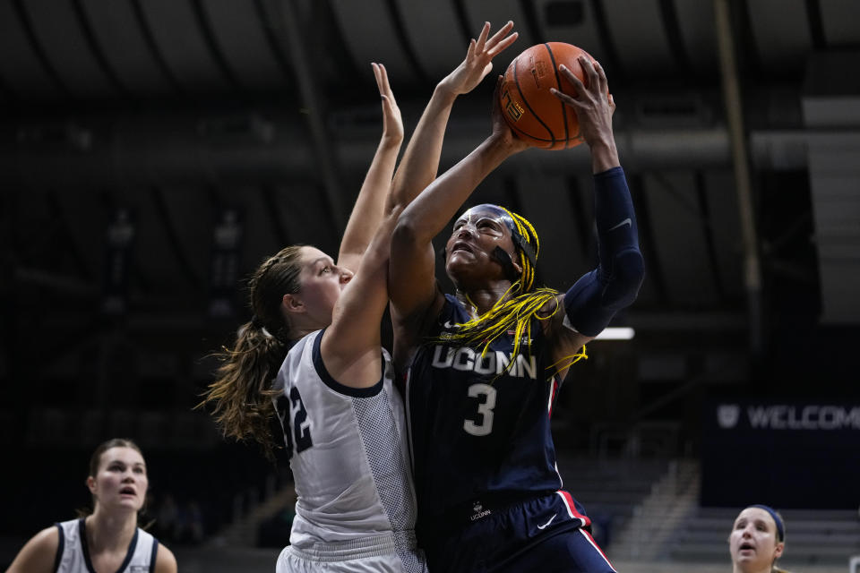UConn forward Aaliyah Edwards (3) shoot over Butler forward Sydney Jaynes (32) during the first half of an NCAA college basketball game in Indianapolis, Tuesday, Jan. 3, 2023. (AP Photo/Michael Conroy)