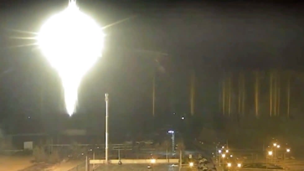This image made from a video released by Zaporizhzhia nuclear power plant shows bright flaring object landing in grounds of the nuclear plant in Enerhodar, Ukraine