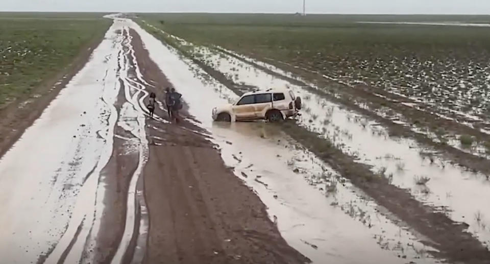 Car bogged on dirt road in Queensland. 