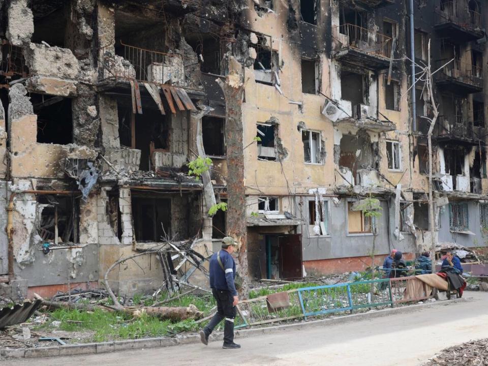 A man walks past a destroyed apartment building in Mariupol on Wednesday, May 4, 2022.  (Alexei Alexandrov/The Associated Press - image credit)