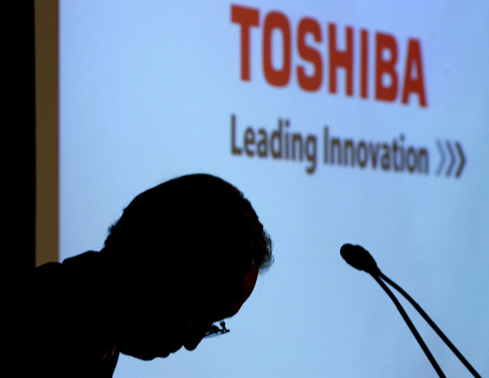 FILE - Toshiba Corp.'s President Satoshi Tsunakawa bows during a press conference at the company's headquarters in Tokyo on April 11, 2017. Chief Executive Tsunakawa is stepping down as the embattled Japanese technology giant seeks to restructure and restore its reputation. Tsunakawa will be replaced by Taro Shimada, an executive officer and corporate senior vice president, under a decision made at a Toshiba board meeting Tuesday, March 1, 2022, the Tokyo-based company said.(AP Photo/Shizuo Kambayashi, File)