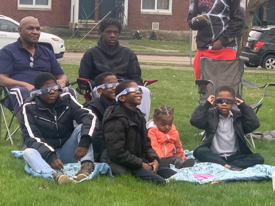 Visitors at the John Jones Museum in Elmira try out their eclipse glasses prior to the start of the show Monday, April 8, 2024.