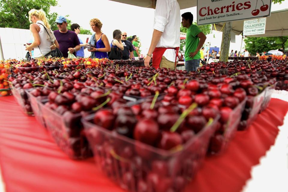 In this July 2, 2011, file photo, cherries from Edmondson Orchards are sold near the Open Space during the opening day of the National Cherry Festival in Traverse City, Mich. The week-long National Cherry Festival in Traverse City, which this year runs from June 29 to July 6, pays homage to the region's signature fruit. Michigan is the nation's top producer of tart cherries _ the ones used for pie filling. (AP Photo/The Record-Eagle, Keith King)