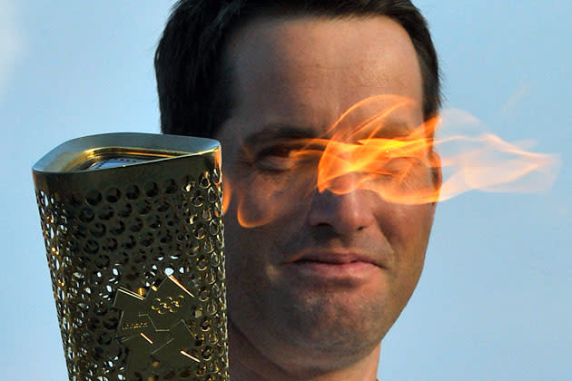 British Olympic sailor Ben Ainslee carries the Olympic torch on the first leg of its Britain, Northern Ireland and Ireland tour at Lands End in Cornwall, southwest England May 19, 2012. REUTERS/Toby Melville