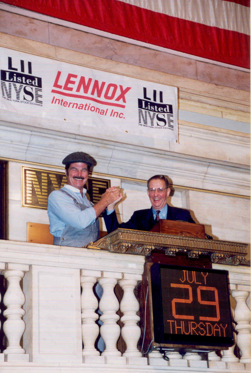 John W. Norris Jr. (right) with the iconic character Dave (Attaboy Dave!) Lennox at the opening bell of the New York Stock Exchange when the company first became publicly traded in 1998. The popular image of Dave Lennox became the company's symbol for over 40 years.