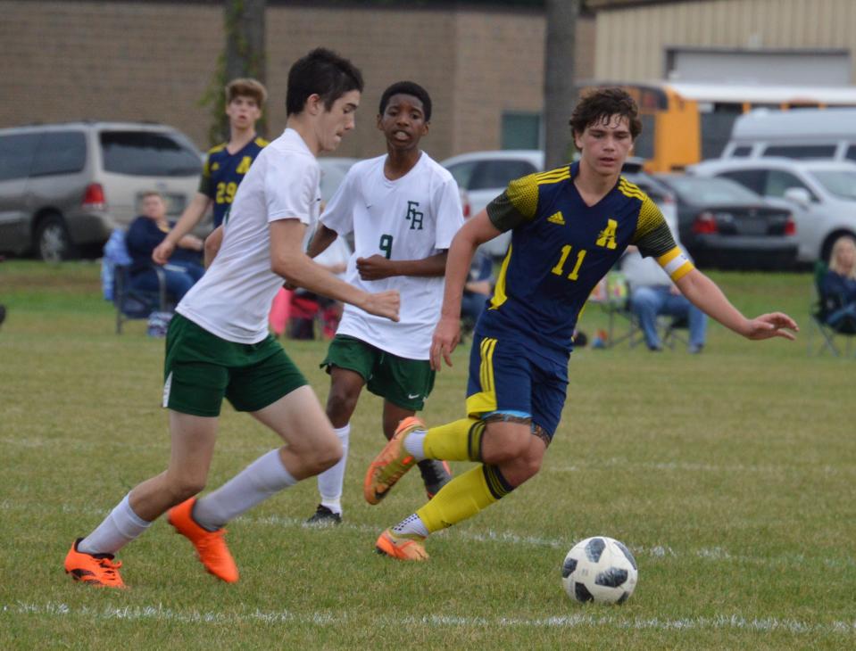 Mitch Hoagland of Flat Rock and Airport’s Nolan Sanders chase the ball Monday. Airport won 4-3 in the opening round of the Huron League Tournament.