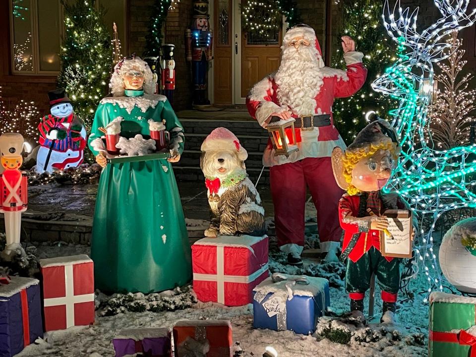 The holiday display at 1422 Bremen Cir. NW in Perry Township has life-sized Santa, Mrs. Claus and elves.