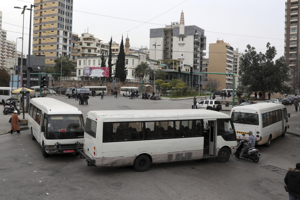 Bus drivers block a road with their vehicles during a general strike by public transport and labor unions paralyzed Lebanon in protest the country's deteriorating economic and financial conditions, in Beirut, Lebanon, Thursday, Jan. 13, 2022. (AP Photo/Bilal Hussein)