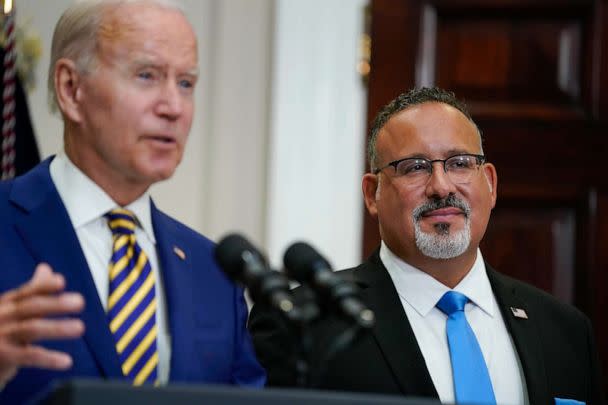 PHOTO: Education Secretary Miguel Cardona listens as President Joe Biden speaks about student loan debt forgiveness in the Roosevelt Room of the White House, Aug. 24, 2022. (Evan Vucci/AP)