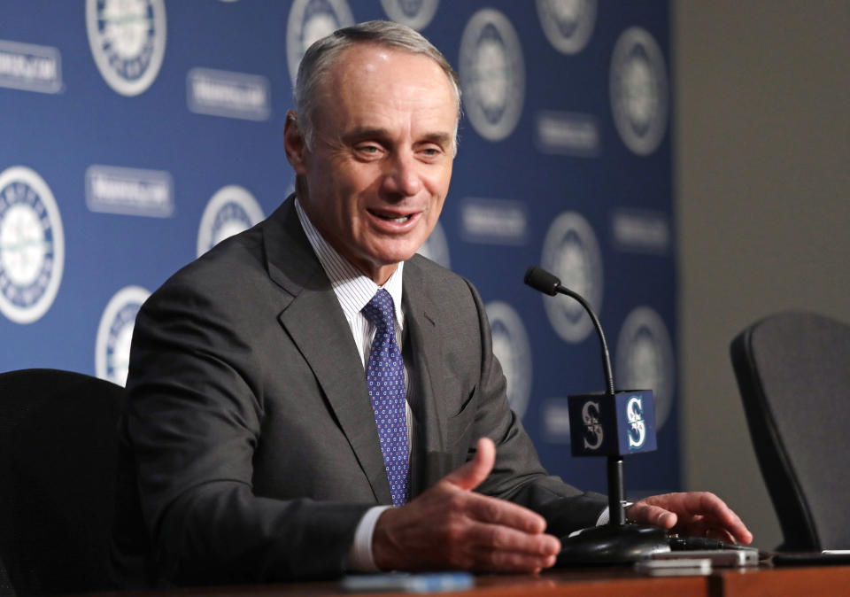 Baseball Commissioner Rob Manfred talks to reporters before a baseball game between the Seattle Mariners and the Houston Astros on Tuesday, June 4, 2019, in Seattle. (AP Photo/Elaine Thompson)