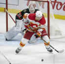 Calgary Flames left wing Matthew Tkachuk tries to deflect the puck past Ottawa Senators goaltender Matt Murray during the second period of an NHL hockey game Thursday, Feb. 25, 2021, in Ottawa, Ontario. (Adrian Wyld/The Canadian Press via AP)