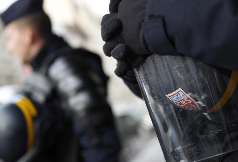 Policemen stand guard during a demonstration of students in Paris, Tuesday, Dec. 18, 2018. France's interior minister is to meet with representatives of police unions, following complaints about working conditions and calls for a work slowdown over what unions say are strained resources after five straight weekends of sometimes violent protests. (AP Photo/Christophe Ena)