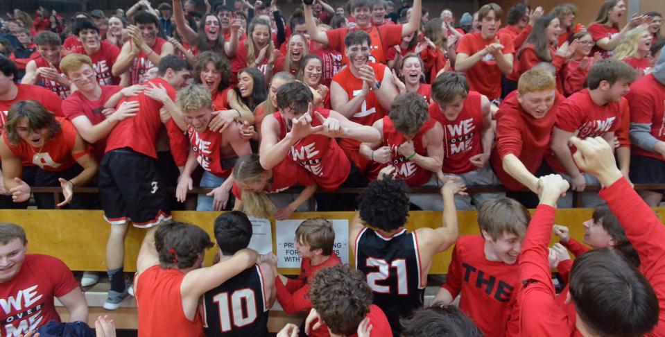 Fairview High School students and players celebrate their 54-51 win over Lincoln Park during a PIAA Class 4A second-round playoff game on Friday.