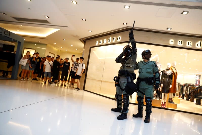 Shoppers and anti-government protesters gather at New Town Plaza in Sha Tin, Hong Kong