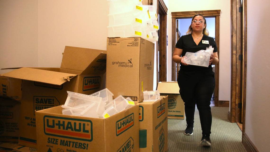 A medical assistant at Grace Women’s Health in Nampa carries supplies to a storage closet April 1.