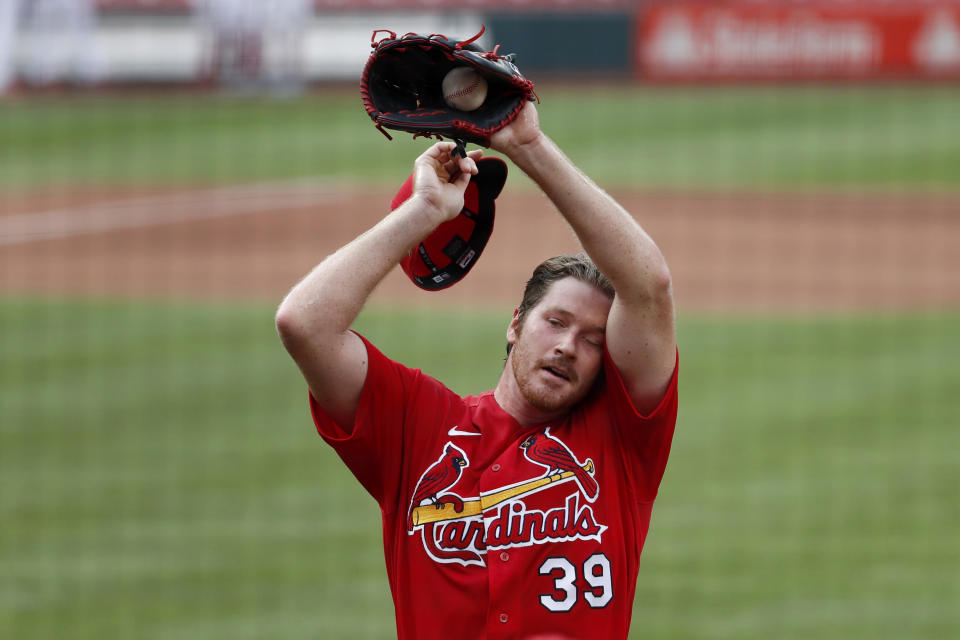 St. Louis Cardinals pitcher Miles Mikolas wipes his face after throwing a simulated inning during baseball practice at Busch Stadium Tuesday, July 7, 2020, in St. Louis. (AP Photo/Jeff Roberson)