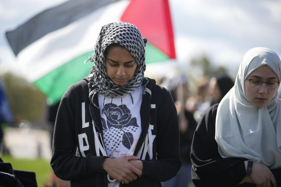 People pray during a rally calling for a ceasefire in Gaza at the Washington Monument, Saturday, Oct. 21, 2023. (AP Photo/Andrew Harnik)