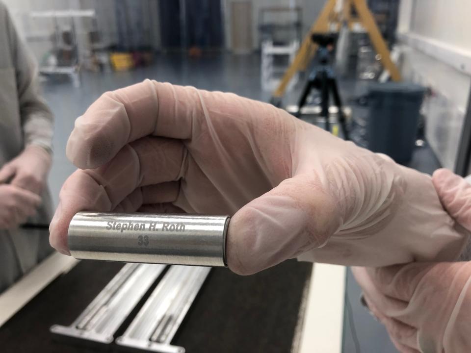 A capsule containing ashes is prepared for placement on a Celestis rocket before it launches into space.