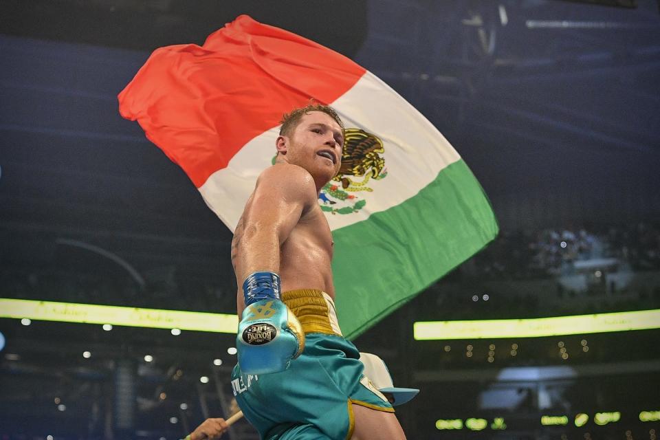 Boxer Canelo Alvarez celebrates defeating Billy Joe Saunders during a super middleweight boxing title fight at AT&T Stadium.