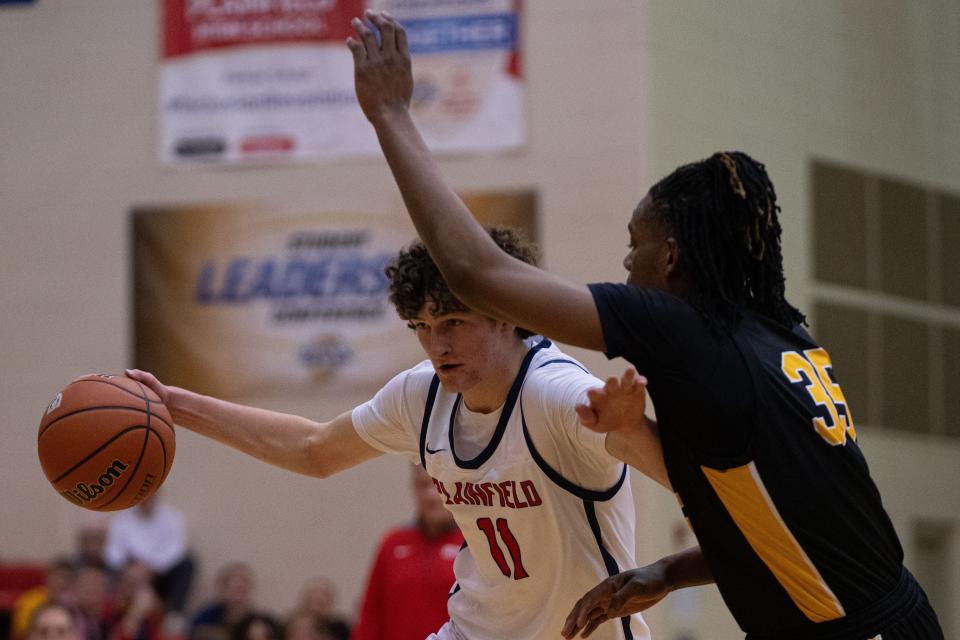 Plainfield Quakers senior Collin Schmidt drives around Avon Orioles junior Kendrick Dunmore Jan 5, 2024, at Plainfield High School in Plainfield, Indiana.