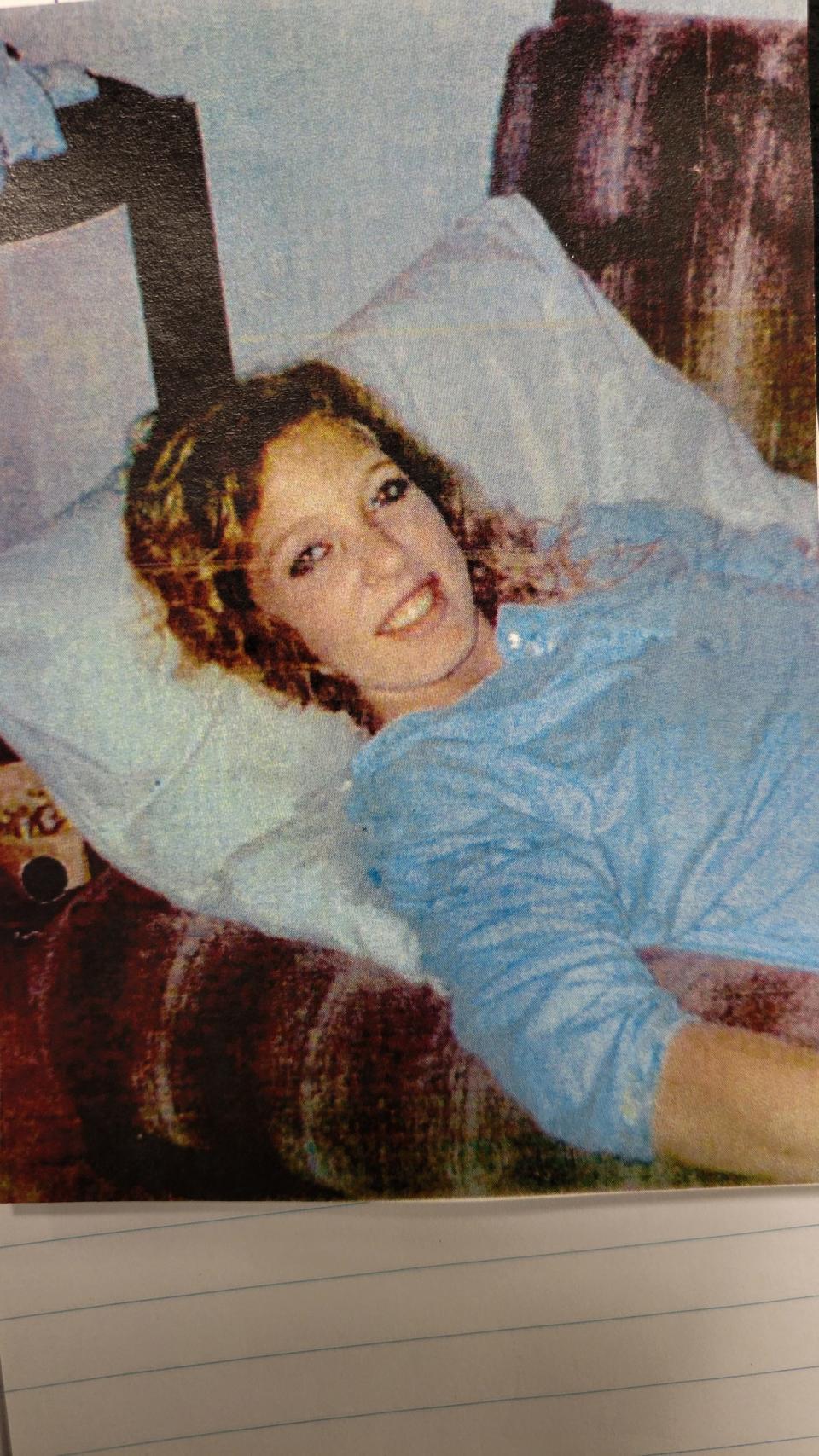 A family photo of Renee McBreen on the sofa where she was found dead by her then-3-year-old son in 1992, according to the Jacksonville Sheriff's Office.