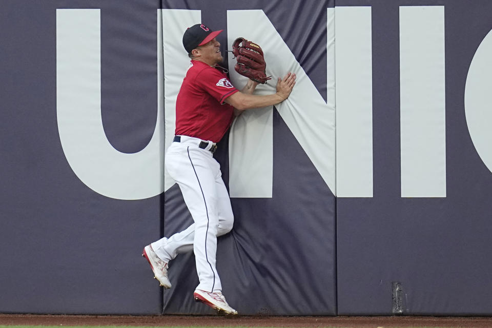 Cleveland Guardians center fielder Myles Straw slams into the outfield wall after catching a fly ball hit for an out by Minnesota Twins' Carlos Correa in the third inning of a baseball game Tuesday, Sept. 5, 2023, in Cleveland. (AP Photo/Sue Ogrocki)