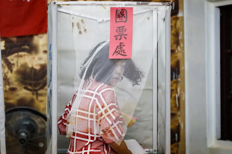 A Taiwanese voter is pictured at a polling booth during the general elections in Kaohsiung