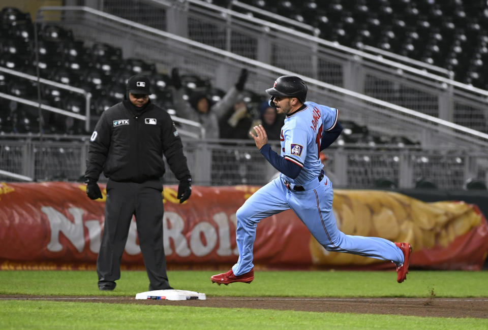 Minnesota Twins' Trevor Larnach rounds third base a single by Miguel Sano during the ninth inning of the team's baseball game against the Detroit Tigers, Tuesday, April 26, 2022, in Minneapolis. The Twins won 5-4. (AP Photo/Craig Lassig)