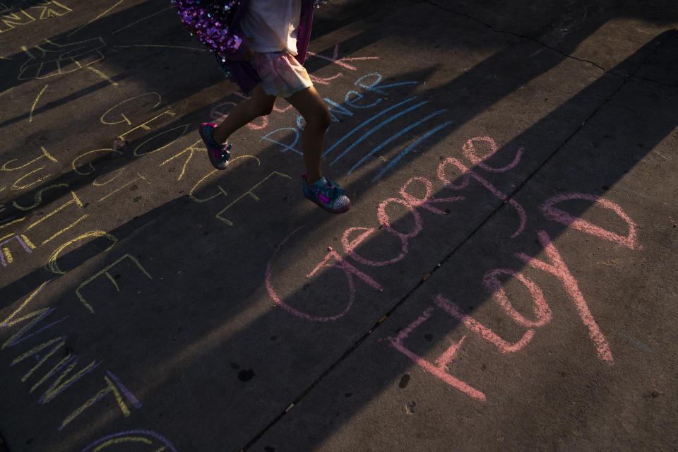 George Floyd's name is written on a sidewalk near the intersection of Florence and Normandie Avenues in Los Angeles, Tuesday, April 20, 2021, after a guilty verdict was announced at the trial of former Minneapolis police Officer Derek Chauvin for the 2020 death of George Floyd. (AP Photo/Jae C. Hong)