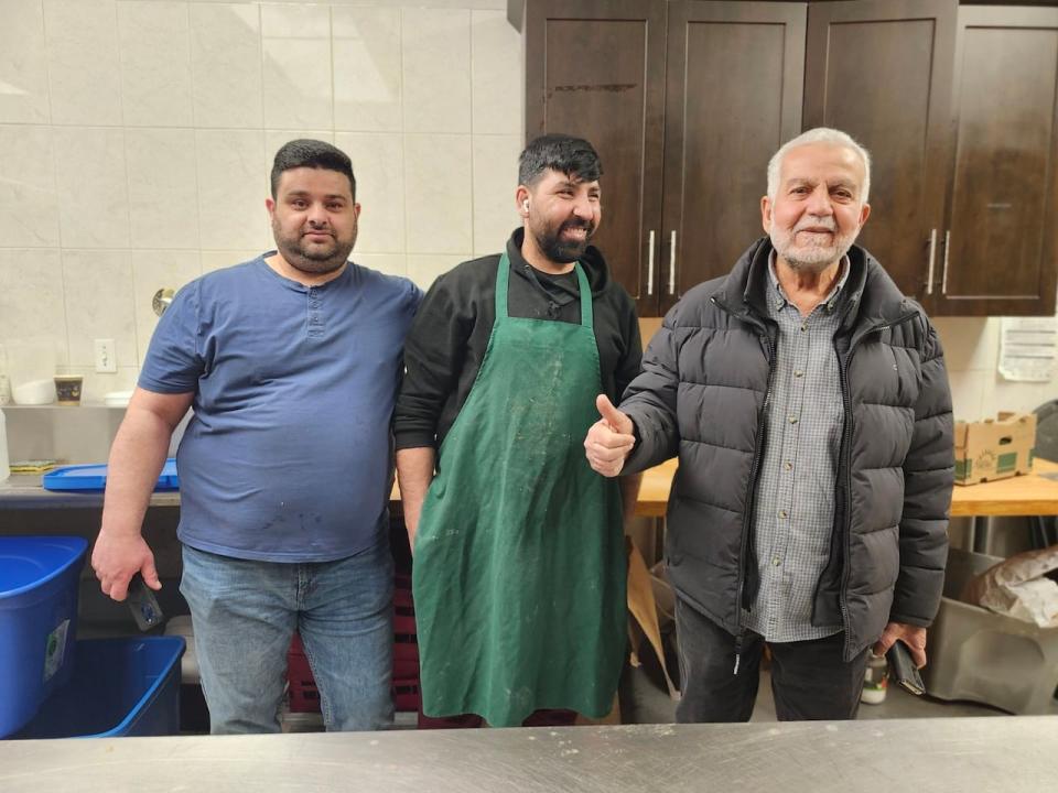 Haitham Murad (left) is joined by other volunteers on the first day of Ramadan at the London Mulim Mosque where food is being prepared for the iftar. 