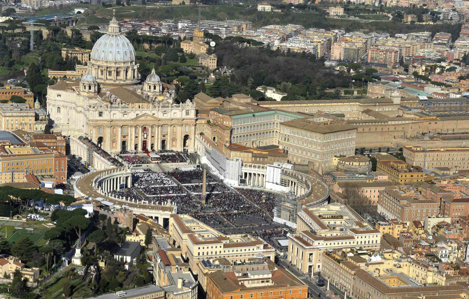 This photo provided by the Italian Police press office shows an aerial view of Saint Peter's Square prior to the start of the installation Mass of Pope Francis at the Vatican, Tuesday, March 19, 2013. Borgo, the sleepy, medieval neighborhood with a timeless feel right outside the Vatican's borders, has been at the service of pontiffs for centuries. From resoling to risotto, from light bulbs to linguine, Borgo is the go-to place for up-and-coming cardinals and sometimes even for popes. (AP Photo/Italian Police, Matteo Losito)