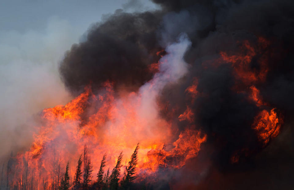 A wildfire burns on Highway 63 south of Fort McMurray, Alberta, Canada, on Saturday, May 7, 2016. Wildfires raging through Alberta have spread to the main oil-sands facilities north of Fort McMurray, knocking out an estimated 1 million barrels of production from Canada's energy hub.<span class="copyright">Darryl Dyck-Bloomberg</span>