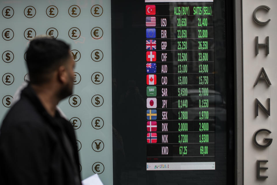 A man looks at figures at a currency exchange shop after the presidential election day in Istanbul, Monday, May 29, 2023. Turkish President Recep Tayyip Erdogan has dissipated a challenge by an opponent who sought to reverse his increasingly authoritarian leanings, securing five more years to oversee the country at the crossroads of Europe and Asia that plays a key role in NATO. (AP Photo/Emrah Gurel)