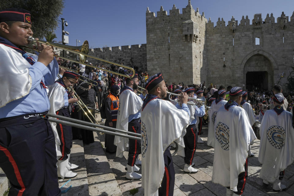 Palestinian scouts play music during celebration of the Islamic holiday of Isra and Mi'raj, next to Damascus Gate just outside Jerusalem's Old City, Monday, Feb. 28, 2022. (AP Photo/Mahmoud Illean)