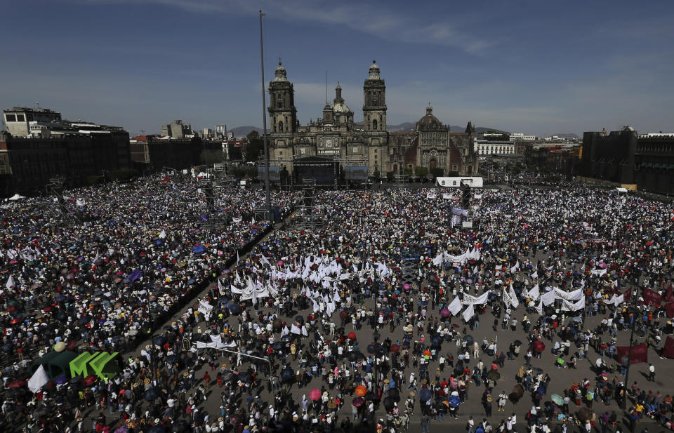 Supporters of Mexico's President Andres Manuel Lopez Obrador gather in the capital's main plaza, at the Zocalo, to join the president in commemorating his one year anniversary in office, in Mexico City, Sunday December 1, 2019. Lopez Obrador took office one year ago, vowing to transform Mexico. He has focused on austerity and fighting corruption because corrupt, high-living politicians have angered Mexicans perhaps more than anything else. (AP Photo/Marco Ugarte)