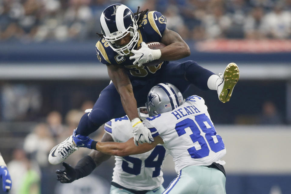 <p>Los Angeles Rams running back Todd Gurley (30) hurdles over Dallas Cowboys safety Jeff Heath (38) in the third quarter at AT&T Stadium. Mandatory Credit: Tim Heitman-USA TODAY Sports </p>