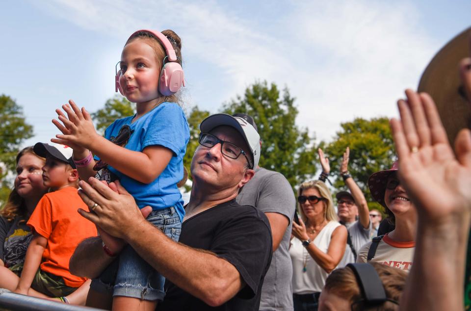 Eliza McLaughlin, 8, is held up by her dad, Danny, at the Gold Record stage watching Brittney Spencer during the Pilgrimage Music Festival at Harlinsdale Farm in Franklin, Tenn., Sunday, Sept. 25, 2022. 