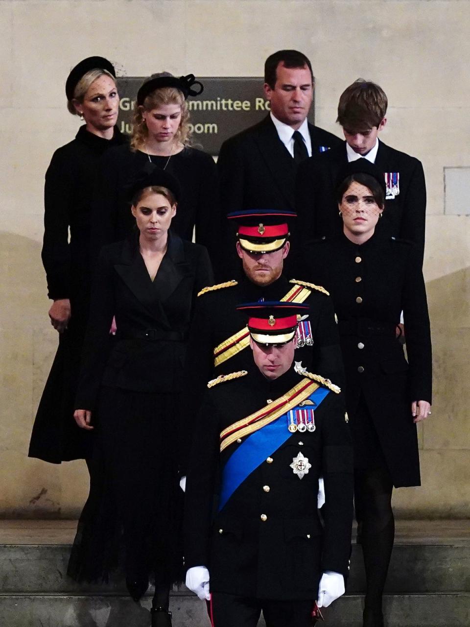 Zara Tindall, Lady Louise, Princess Beatrice, Prince William, the prince of Wales, Prince Harry, Princess Eugenie, Viscount James Severn and Peter Phillips attend the vigil of the Queen’s grandchildren around the coffin, as it lies in state on the catafalque in Westminster Hall (AP)