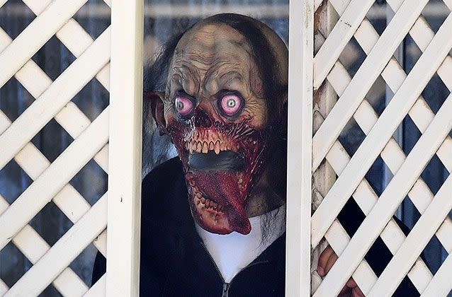 A masked man is seen at the home of Rosleigh Rose, mother of Schapelle Corby in Loganlea, south of Brisbane, Picture: AAP/Dave Hunt