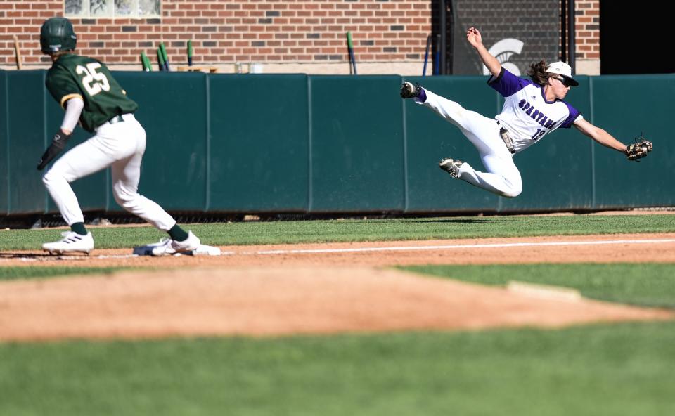 Battle Creek Lakeview third baseman Cade Oxley snags a grounder as Grosse Pointe North's James MacAuley heads home Friday, June 17, 2022, during the MHSAA state semifinal at McLane Stadium in East Lansing. Grosse Pointe North won 8-0.