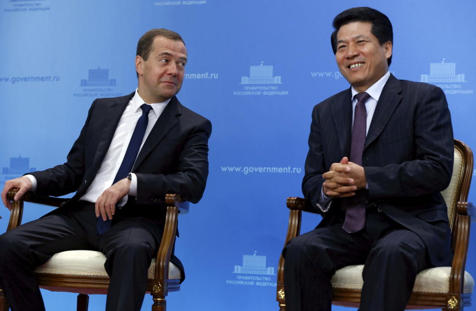 Russian Prime Minister Dmitry Medvedev (L) and Chinese Ambassador to Russia Li Hui attend a video conference, dedicated to the start of the construction of the Chinese section of the Power of Siberia gas pipeline, in Moscow, Russia, June 29, 2015. REUTERS/Dmitry Astakhov/RIA Novosti/Pool ATTENTION EDITORS - THIS IMAGE HAS BEEN SUPPLIED BY A THIRD PARTY. IT IS DISTRIBUTED, EXACTLY AS RECEIVED BY REUTERS, AS A SERVICE TO CLIENTS.  